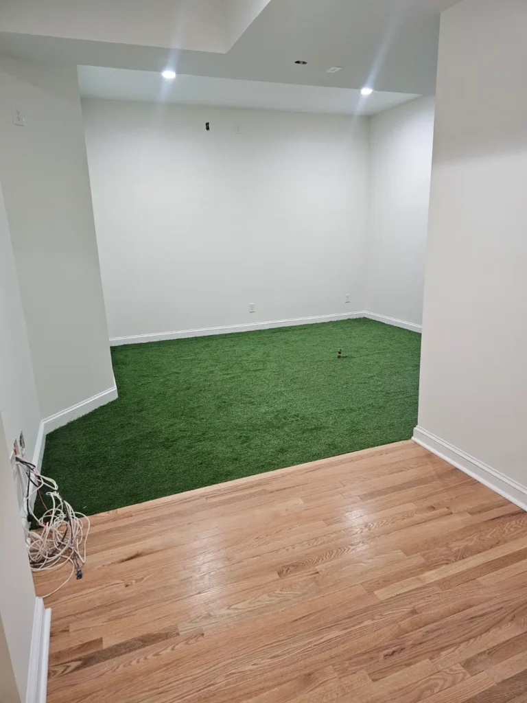 Room with artificial grass and wood floor